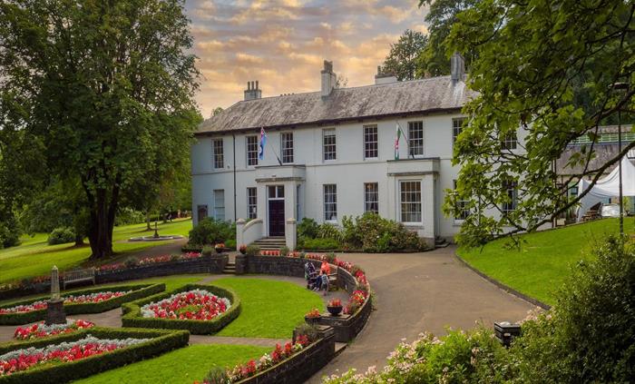 The main house with the circular gardens in the front of the house.